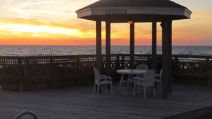 A gazebo with a sign reading "MUMBLE HUT" overlooking the ocean at sunset. - Pet-Friendly Beach Retreat Near Pool/Pickle Ball Courts With Weekly Discounts! (Port St Joe)