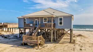 A beach house with a wooden deck, a staircase, and a view of the ocean. - Custom Beach House Steps to Beach w/ Through Lot + Panoramic Views (Dauphin Island)