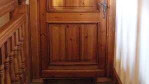 A wooden door with a number '9' above it, a metal handle, and a small sign with text. - Apartment in Chalet- LES HOUCHES in Résidence de Tourisme MGM (Les Houches)