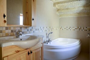 A bathroom with a double sink, a bathtub, and wooden cabinets. - Relaxing, Quiet Village On Gozo Island (Gharb)