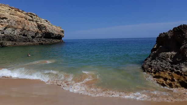 A beach with clear water, a swimmer, and rocky cliffs. - Large Villa with own Pool, 4 Bedrooms, Family Friendly, Shaded Pavillion. (Vale Covo, Loule)