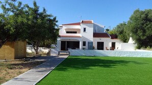A two-story house with a red-tiled roof, a covered patio, and a well-maintained lawn. - Large Villa with own Pool, 4 Bedrooms, Family Friendly, Shaded Pavillion. (Vale Covo, Loule)