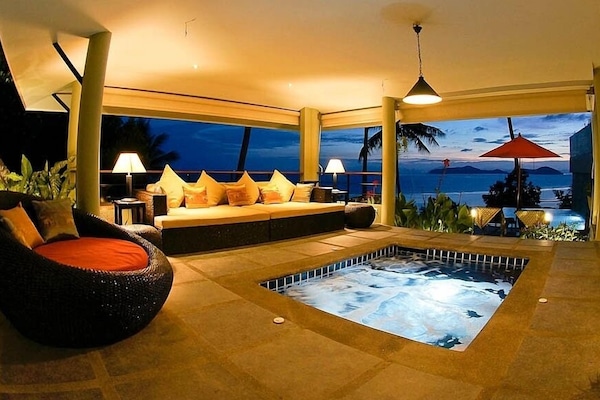 Evening view of the living area with illuminated jetted plunge pool