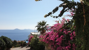 A coastal road with a view of the sea and distant mountains. - Luxury Villa, Private Pool, Beautiful Gardens, Stunning Sea & Mountain Views (Kalkan)
