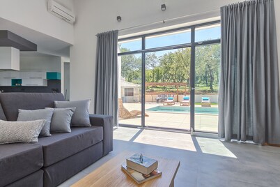 Modern peaceful villa with large pool in green surroundings offering privacy