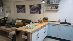 A modern kitchen with a built-in island, light blue cabinets, and a wooden countertop. -  TORREMAR APARTMENT IN FRONT OF THE SEA.  VT- 450557-A (ALICANTE/ALACANT)