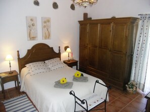Cozy retreat with a large bed, two bedside lamps, and a stylish wardrobe.