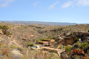 A rugged landscape with rocky terrain and sparse vegetation.