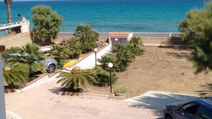A coastal view with a clear sky, a sandy beach, and a parked car. - Noto Lido (Syracuse Sicily Italy), Adriana Residence on the Beach by the Sea !!! (Lido di Noto)