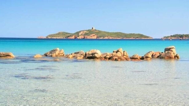 A beach with clear shallow waters, large rocks, and a hill with a structure on top. - mansion - 8 rooms - 12/13 persons (Porto Vecchio)