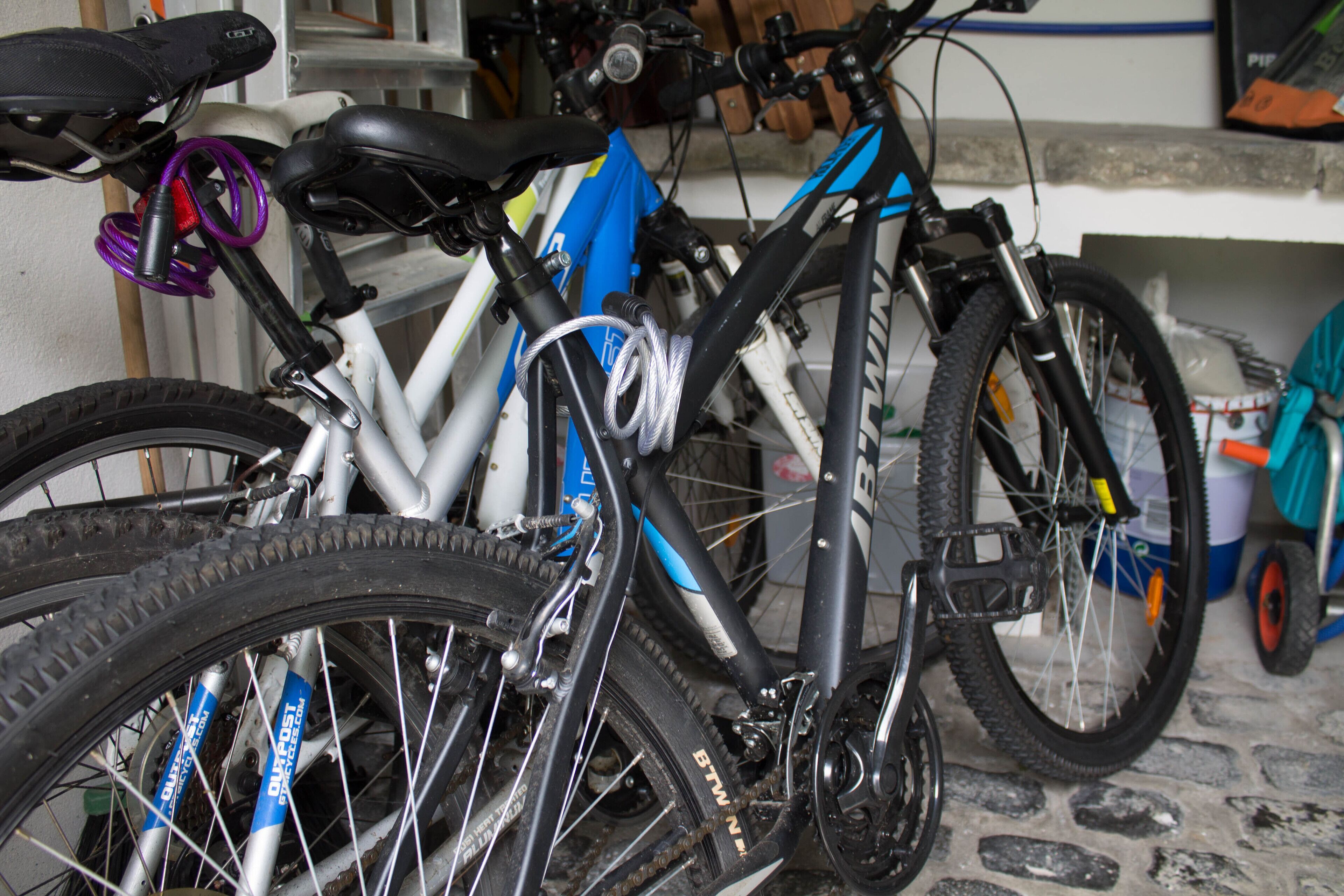A bicycle with a black seat and a white frame, parked indoors.