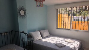 A bedroom with a bed, a chair, and a small table. - 4 Bedroom Townhouse With Pool Close To Town, Beach And Park - Free WiFi (Benalmadena Cost)