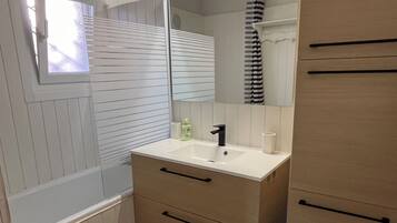 Bathtub, hair dryer, towels, soap