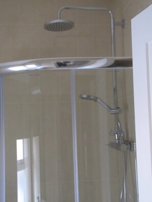 A shower enclosure with a handheld showerhead and a wall-mounted faucet. - 3 bedroom, sleeps 6, beautiful Village in the centre of Ireland  (Multyfarnham)