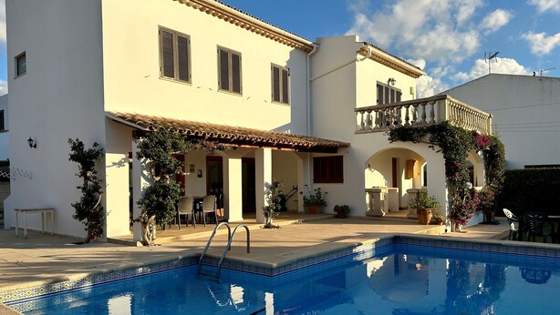 A two-story house with a swimming pool, outdoor seating, and a balcony with a railing. - "Casa Montana" Holiday house for 6 persons with Private Pool (Puerto Pollensa)