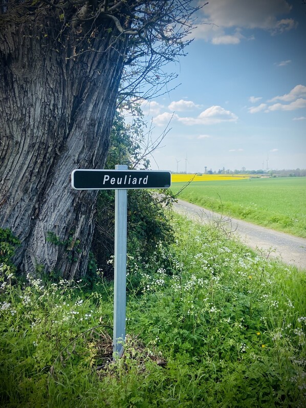 A rural road sign with 'Peuiliard' written on it, surrounded by greenery and a clear sky. - Charming, Detached Farmhouse With Private Swimming Pool. (Lizant)