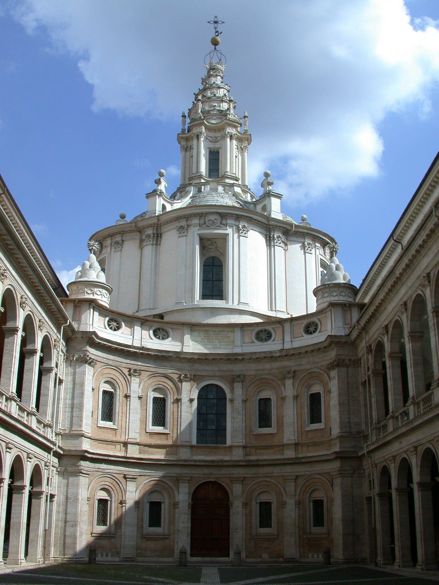 A historic building with a central dome, arched windows, and a symmetrical facade.