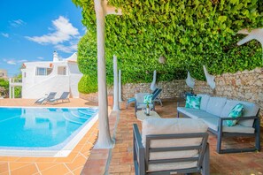 A heated pool, sun loungers