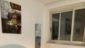 A neatly made bed with a quilted bedspread, two pillows, and rolled towels on the bed. - apartment/ flat - with a large terrace overlooking the sea (Taormina)