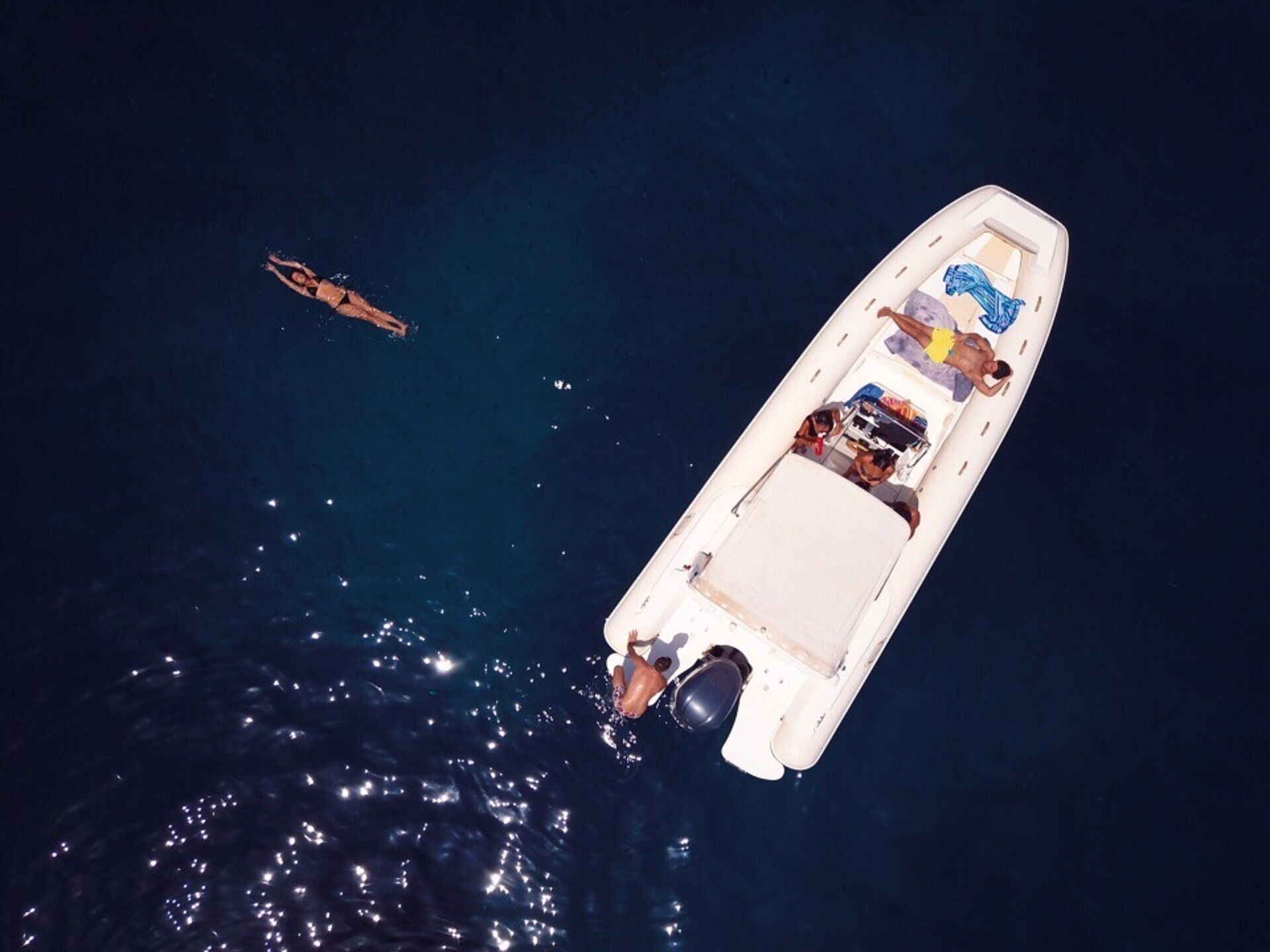 A boat with a covered deck and a motor at the stern.