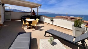 A rooftop terrace with a table and chairs, a lounge chair, and a view of the sea. - Casa Anna 800 meters from the SEA .... (Balestrate)