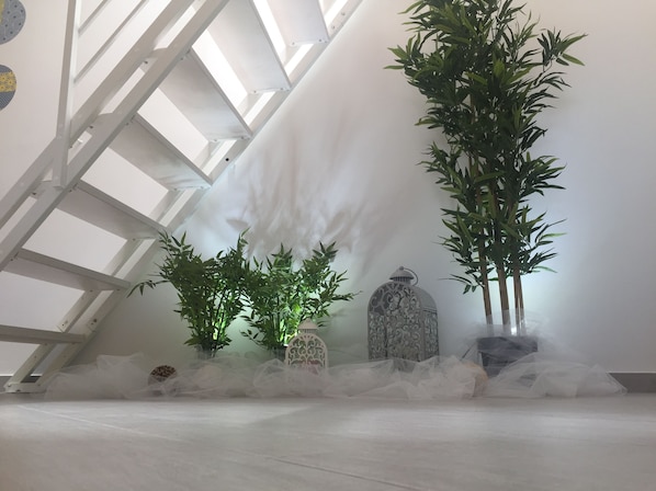A room with a sloped ceiling, a large window, and a decorative lantern. - Anna's House. (Balestrate)