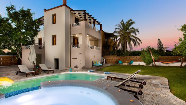 A two-story house with a swimming pool, lounge chairs, and a hot tub. - Aestas Residence, Refined Summer Retreat with Pool, Spa Whirlpool & Ping Pong (Rethymno)