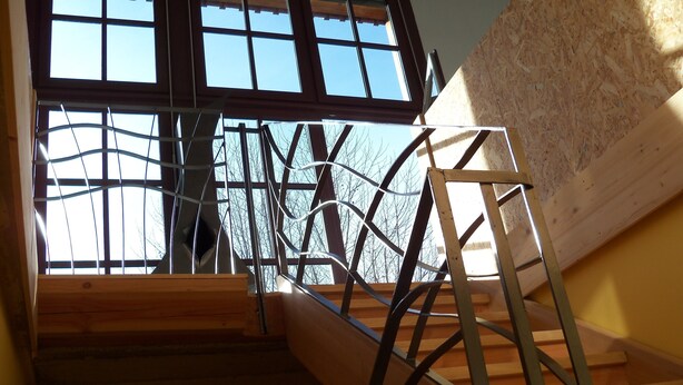 A construction site with exposed wooden beams and metal scaffolding.