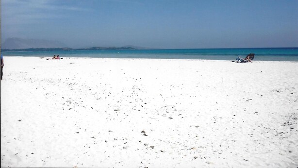 Una playa con arena blanca y agua cristalina.
