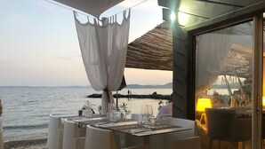 A table set for two with a view of the sea and distant mountains. - Air-conditioned villa, sea view and only 500m walk to sandy beach and San Peire! (Roquebrune-sur-Argens)