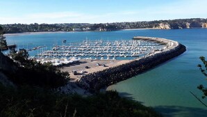 A marina with numerous boats docked, surrounded by rocky terrain and a clear view of the coastline. - LE BIGORNEAU IMPRENABLE VIEW of the MORGAT CROZON BEACH (Crozon)