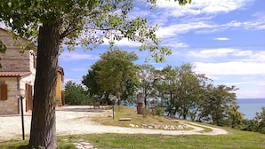 Ein Steinhaus mit einem Kiesweg, der zu einer Bank und einem Picknicktisch führt.
