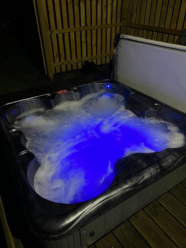 A hot tub with a blue light. - Bluebell Cabin - Charming, Well Equipped Log Cabin with hot tub & free wi-fi. (Taynuilt)