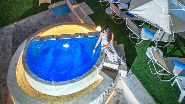 A swimming pool area with a hot tub, lounge chairs, and umbrellas. - Nereid Villa, with Heated Pool & Heated SpaWhirlpool, BBQ, Impeccable SeaViews (Rethymno)