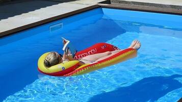 Een buitenzwembad en een verwarmd zwembad