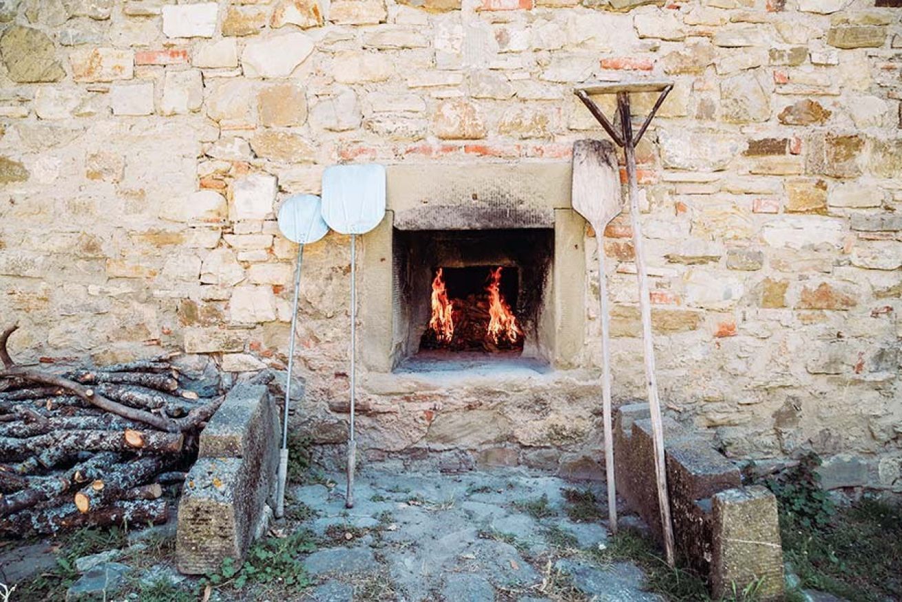 A stone wall with a fireplace.