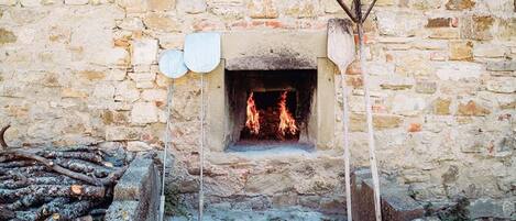 A stone wall with a fireplace.
