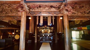 An ornate wooden entrance with intricate carvings and a sign with Chinese characters. - Ryutakuzenji (Takasaki)