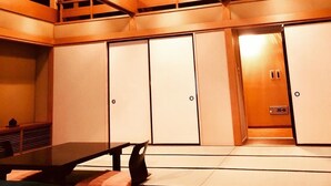 A multi-level room with wooden beams, a table, and chairs. There are doors and a small elevator. - Ryutakuzenji (Takasaki)