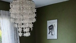 A bedroom with a wooden bed, a hanging light fixture, a green wall, and a window with curtains. - House / Villa - Lège-Cap-Ferret (Lège-Cap-Ferret)