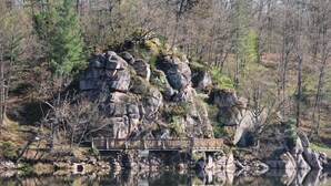 A rocky landscape with a wooden bridge over a calm body of water, surrounded by trees. - COMFORT air-conditioned house with garden, terrace in Medieval City in Burgundy (Semur-En-Auxois)