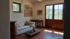 A living room with a sofa, a coffee table, and a wooden door.