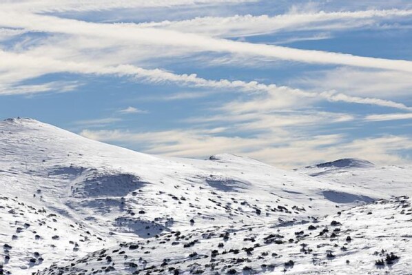 A snowy mountain landscape with clear skies.