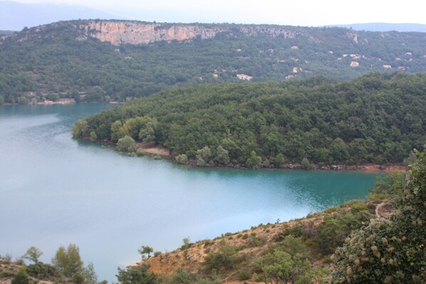 A lake surrounded by dense forest and hills.