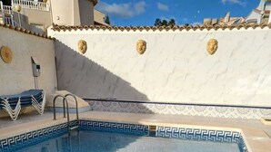 A swimming pool with a tiled border and a lifeguard stand. - Exclusive Villa With Private Pool
 (Ciudada Quesada)