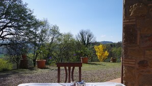 An outdoor dining table with a view of a garden and trees. - House in Val d'Orcia perfect for relaxation CIN IT052024C2APXZK7PD  (RADICOFANI)