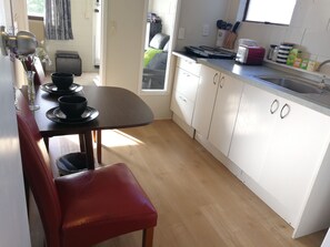 Family Room, Kitchen, Sea View (# 5) | Private kitchen | Full-sized fridge, microwave, stovetop, cookware/dishes/utensils - Harbour View Guesthouse (Auckland)