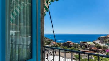 Enjoy breathtaking views of the sea and coastal town from this balcony.