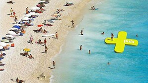 Una spiaggia con ombrelloni e persone.