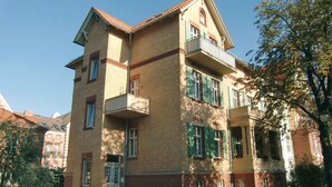 A multi-story building with a brick facade, balconies, and a gated entrance. - Apartment in Potsdam - Berlin suburb - near Holy Lake -<br><br> (Potsdam)
